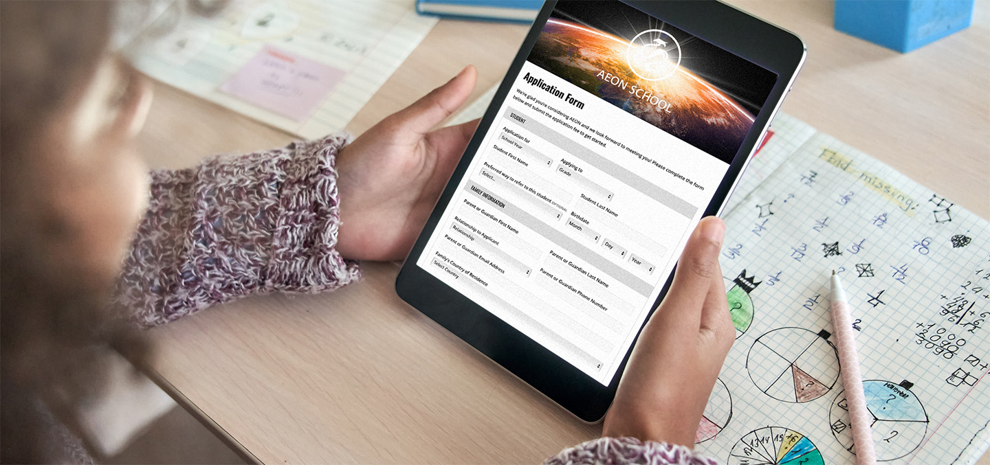 the application form for AEON School is displayed on a tablet