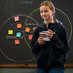 a student gives a presentation in a classroom