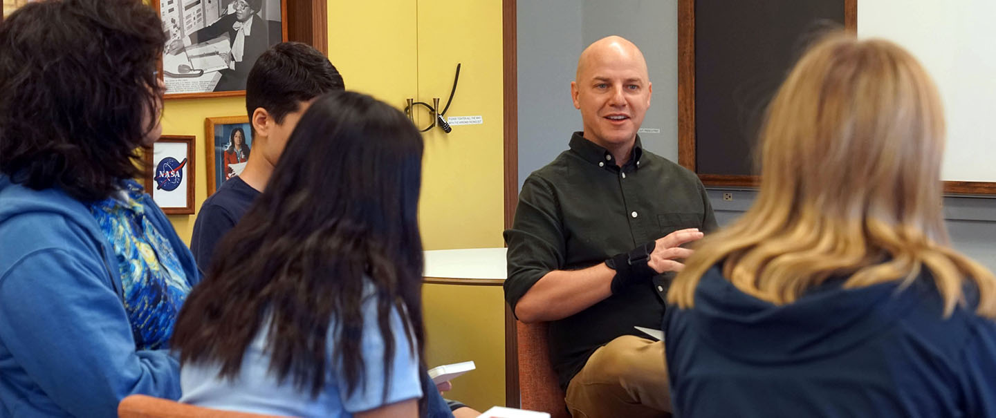 A teacher sits in dialogue with students at AEON School in Silicon Valley