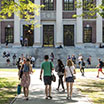 students walk toward a university building